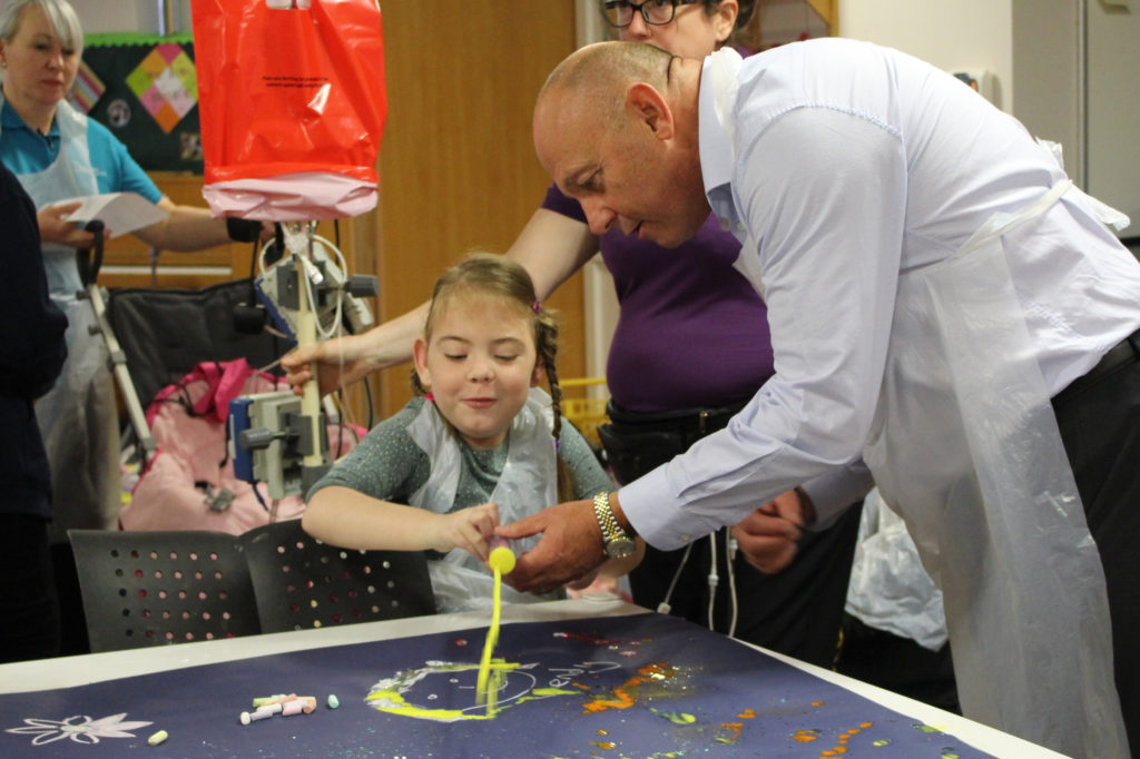 Keith Soulsby takes part in a painting session with children at St Oswald's Hospice