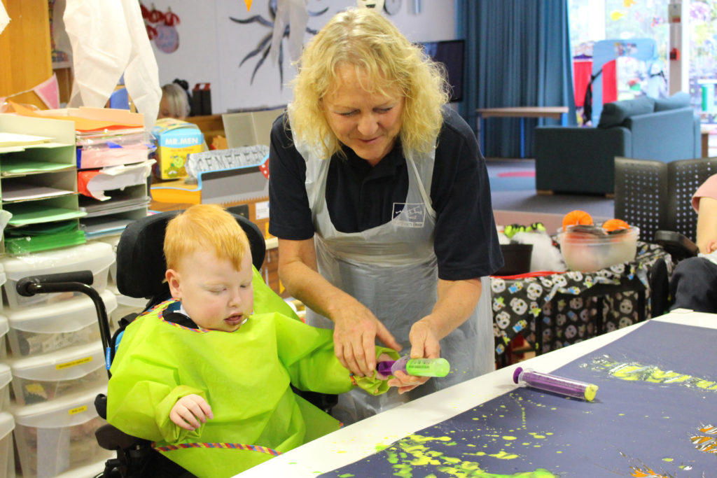 Wendy Edgell takes part in a painting session with children at St Oswald's Hospice